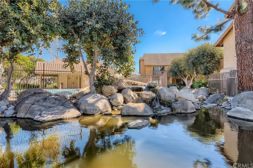 207 Orange Blossom, Unit 23 Irvine, CA 92618 - Photo 21 of 28 a view of a lake with couches and a fire pit