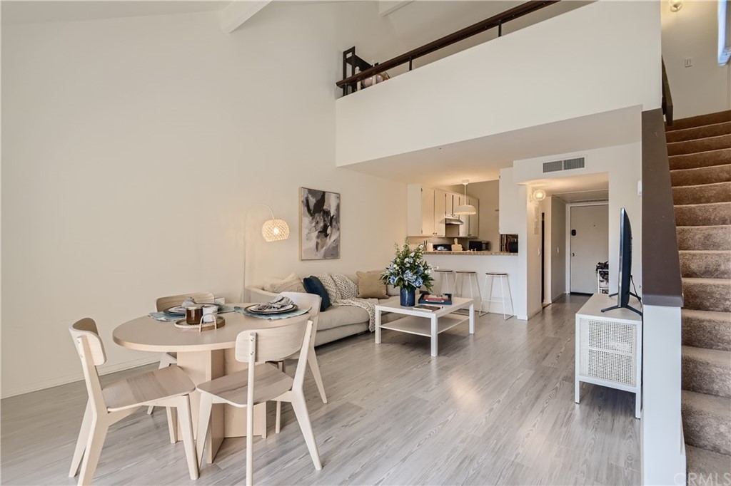 207 Orange Blossom, Unit 23 Irvine, CA 92618 - Photo 4 of 28 a dining room with furniture and wooden floor
