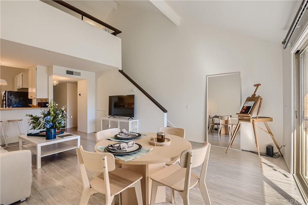 207 Orange Blossom, Unit 23 Irvine, CA 92618 - Photo 10 of 28 a view of a dining room with furniture and wooden floor