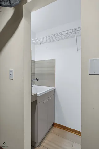 a view of cabinets and utility room with wooden floor
