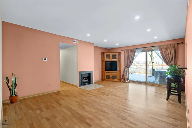 an empty room with furniture and a large window