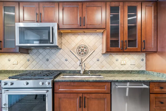 a stove top oven sitting inside of a kitchen