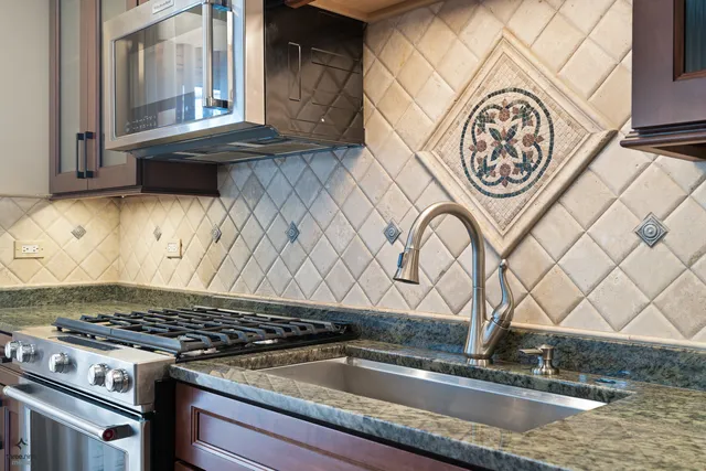 a view of a kitchen sink and a stove