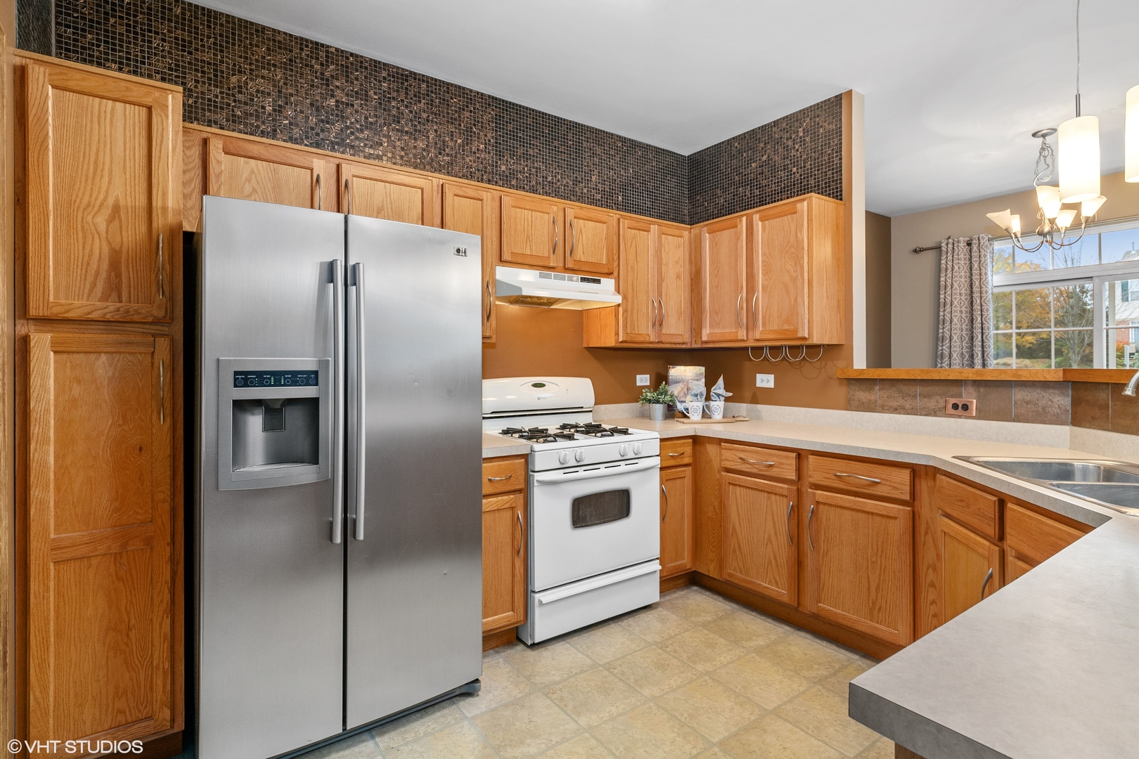 611 North Red Deer Road, Unit 433402 Round Lake, IL 60073 - Photo 6 of 15 a kitchen with stainless steel appliances granite countertop a refrigerator sink and cabinets