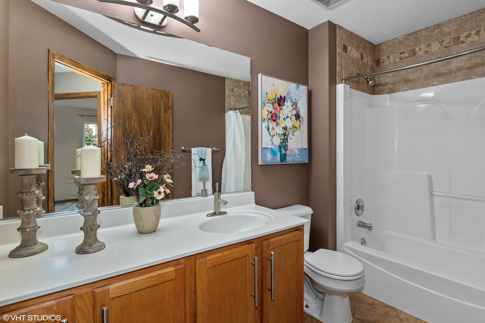 611 North Red Deer Road, Unit 433402 Round Lake, IL 60073 - Photo 9 of 15 a bathroom with a sink a toilet and shower curtain