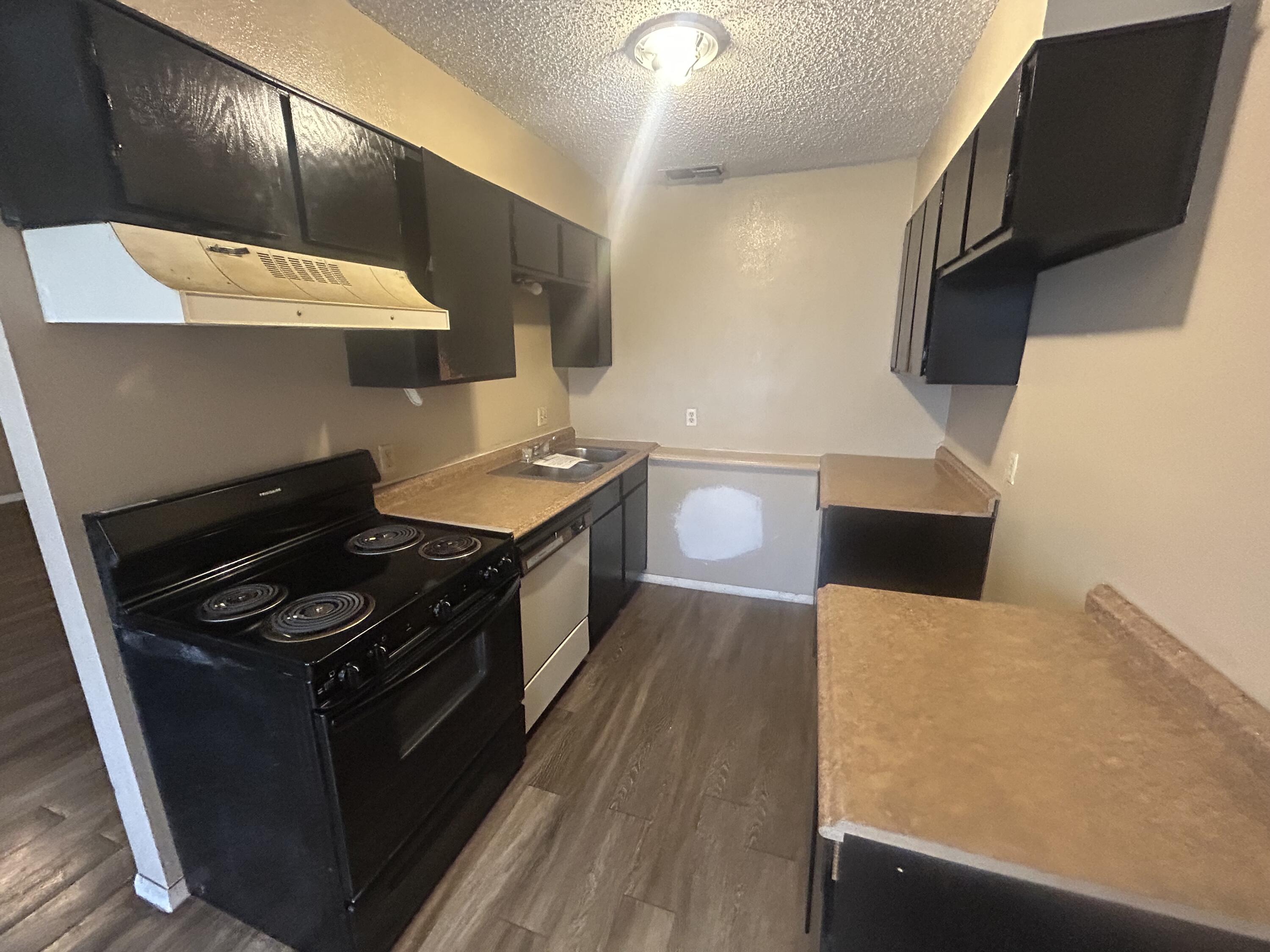 100 Pecos Place Plainview, TX 79072 - Photo 14 of 32 a kitchen with a stove and a microwave