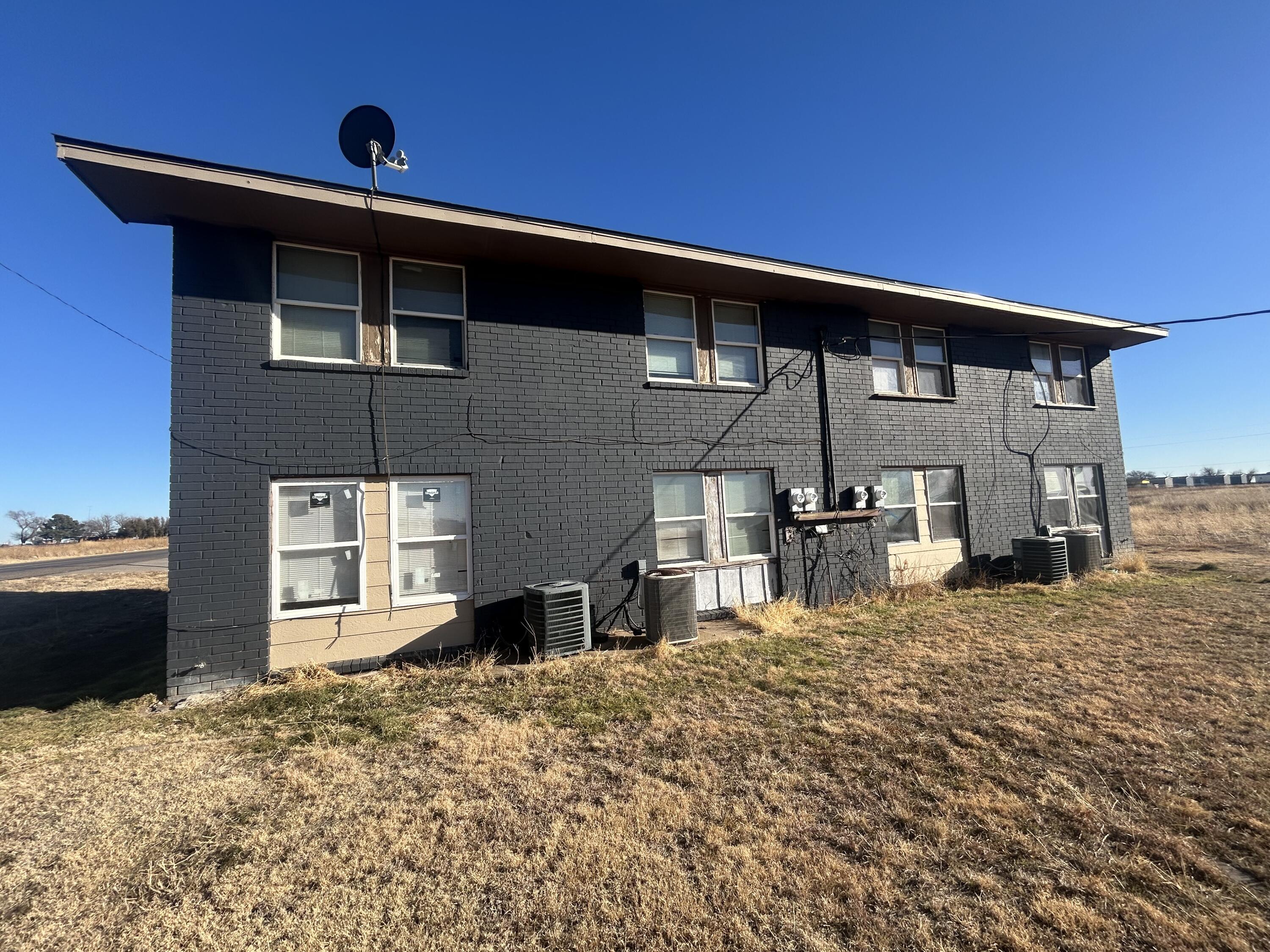 100 Pecos Place Plainview, TX 79072 - Photo 2 of 32 a front view of a house with a yard