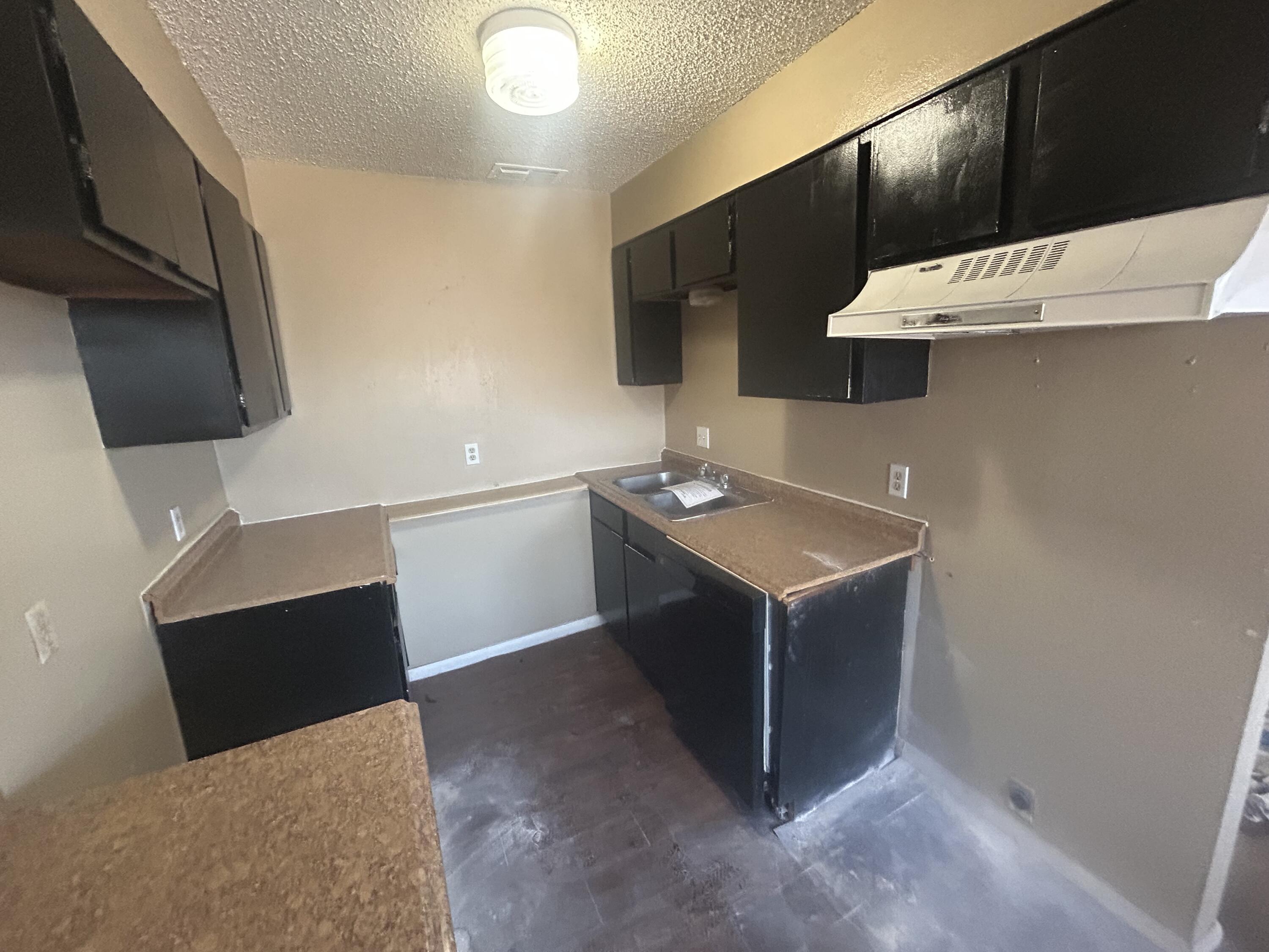 100 Pecos Place Plainview, TX 79072 - Photo 21 of 32 a kitchen with a sink and a stove top oven