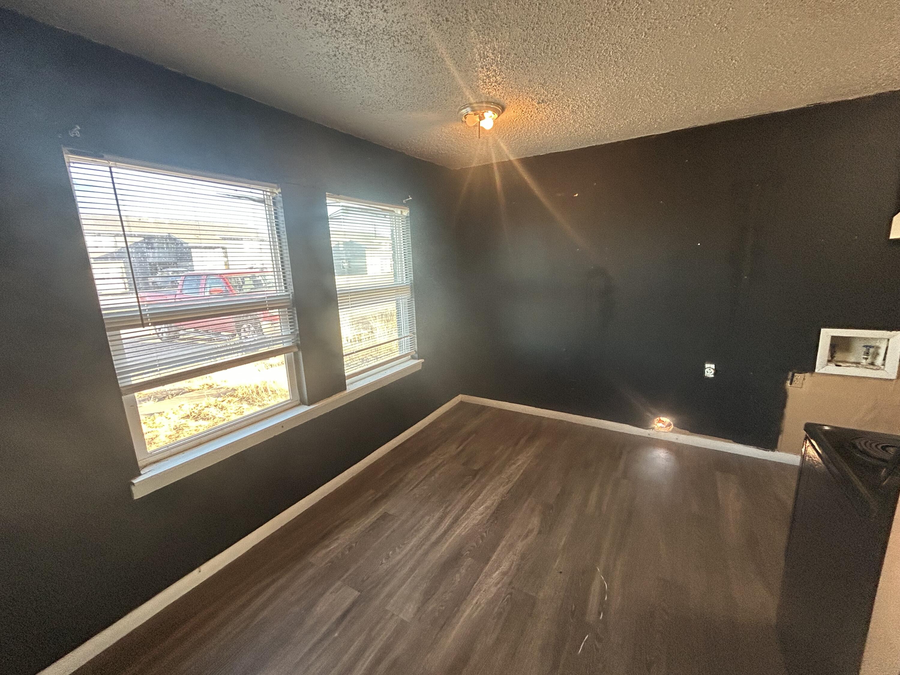 100 Pecos Place Plainview, TX 79072 - Photo 27 of 32 a view of an empty room with wooden floor and a window