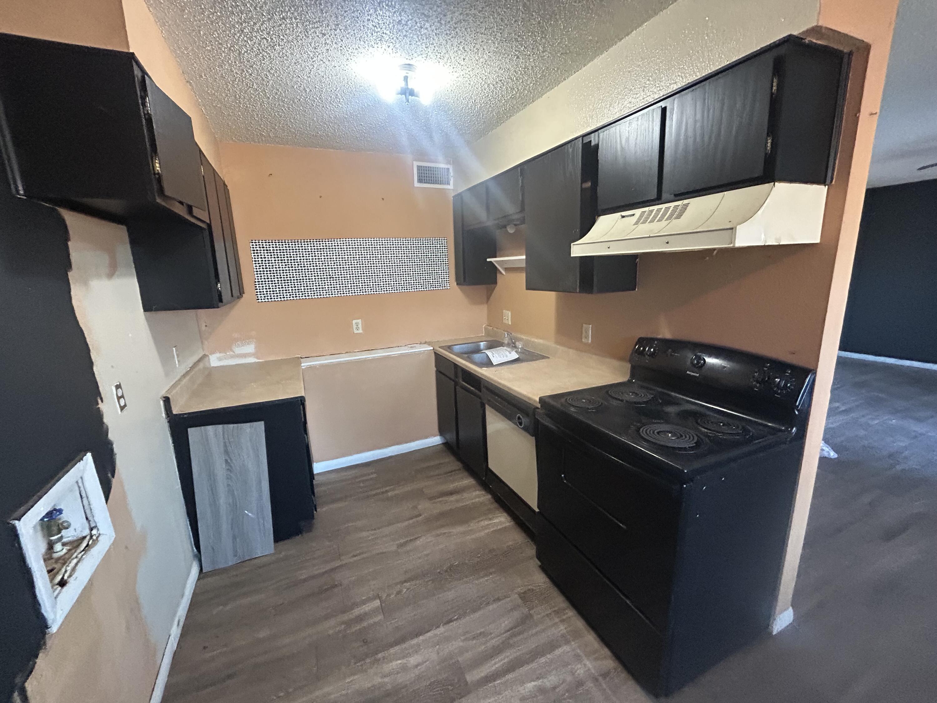 100 Pecos Place Plainview, TX 79072 - Photo 28 of 32 a kitchen with a stove and a refrigerator