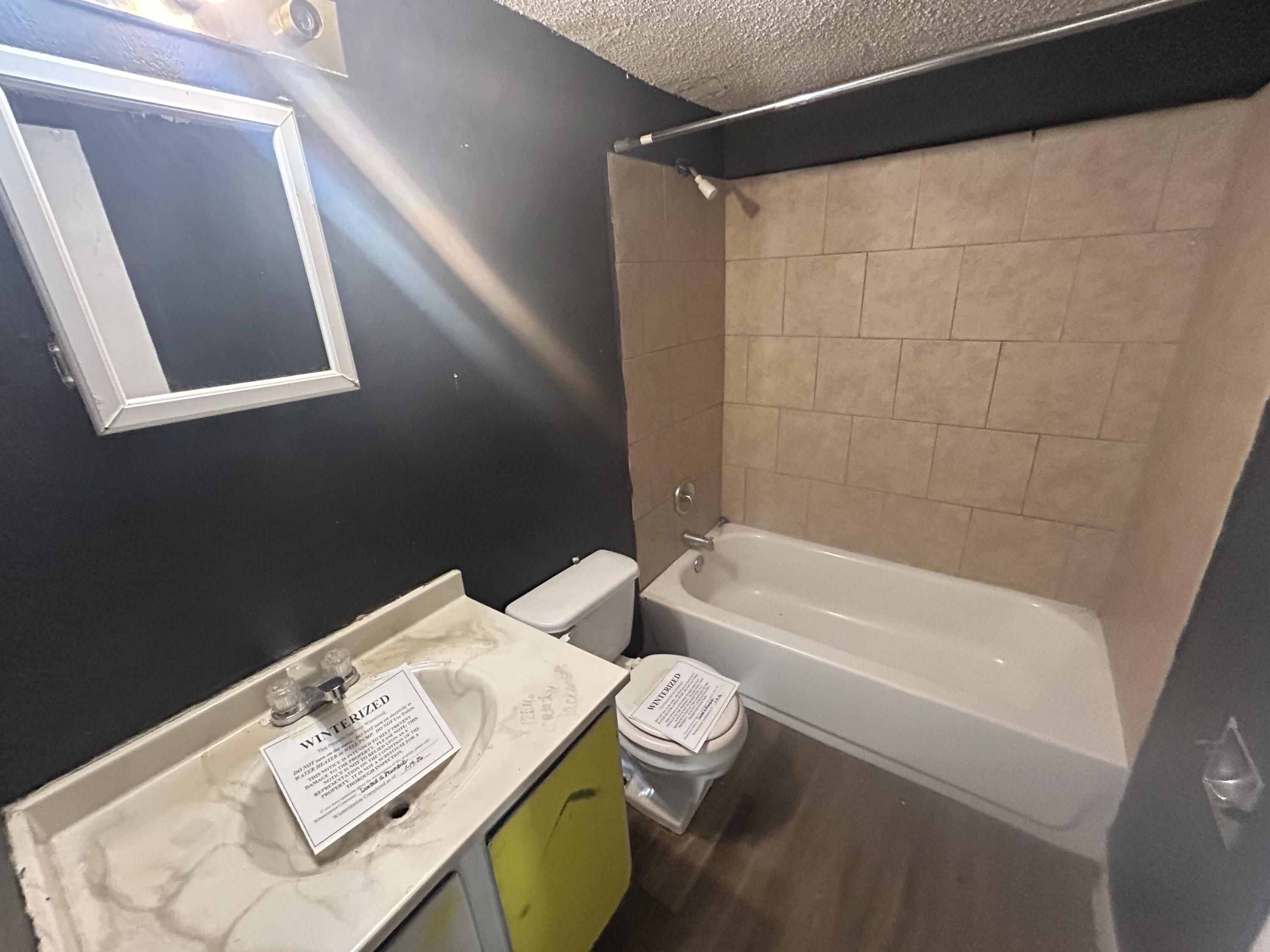 100 Pecos Place Plainview, TX 79072 - Photo 32 of 32 a bathroom with a sink a bathtub and a shower