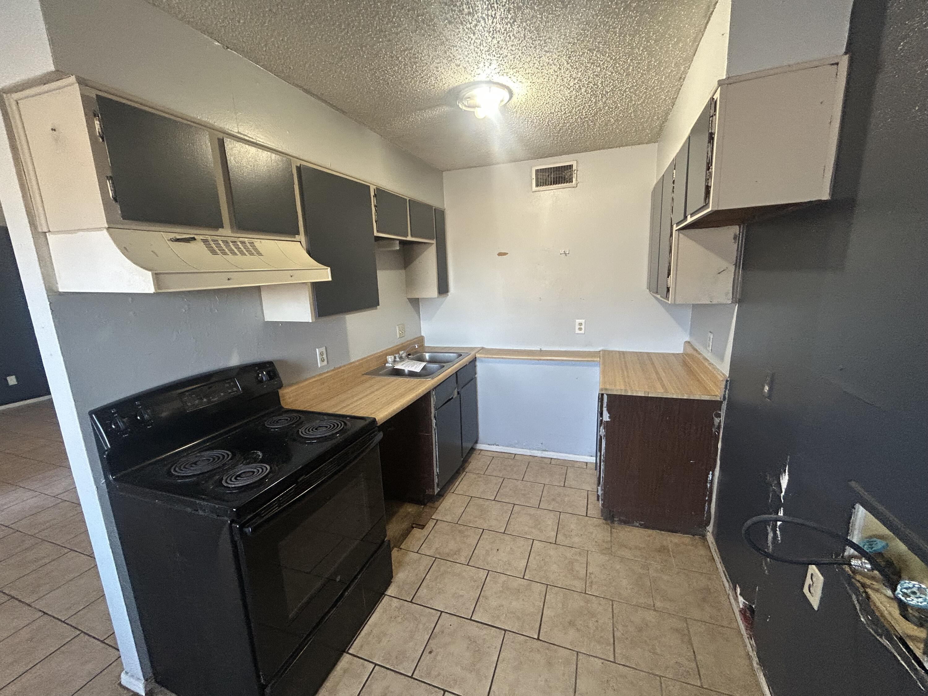 100 Pecos Place Plainview, TX 79072 - Photo 7 of 32 a kitchen with a stove and a refrigerator