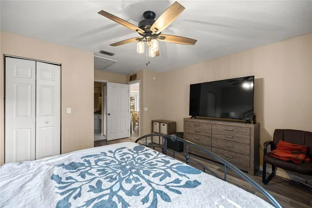 a bedroom with a bed and a flat screen tv