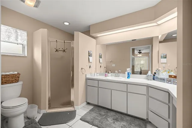 a view of bathroom with a toilet sink a mirror and shower