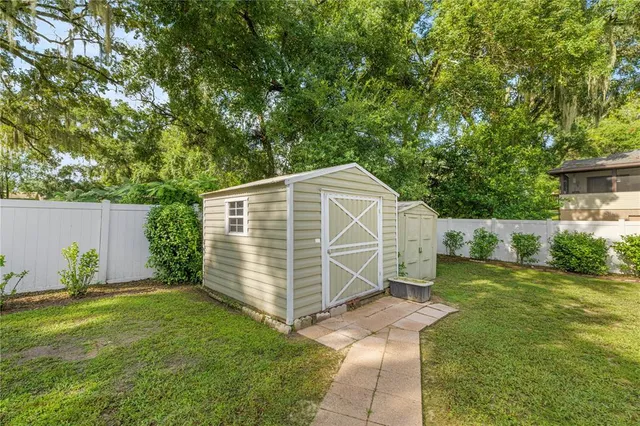 a view of a backyard with small cabin