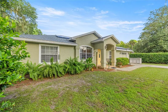 a front view of house with yard and green space