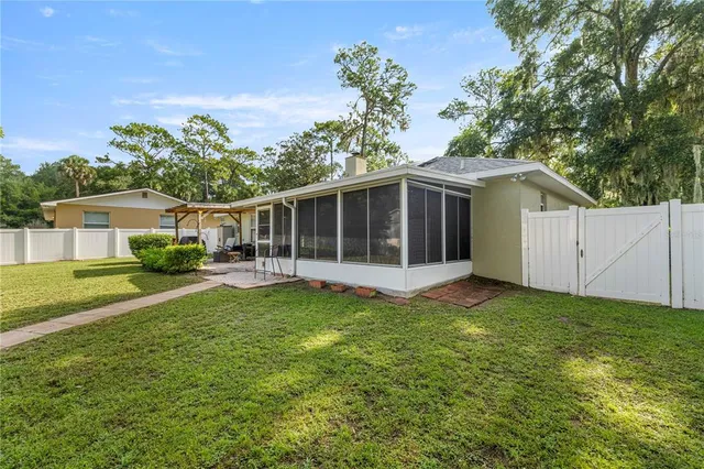 a view of a house with a yard and a garden