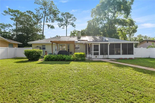 a view of a house with a backyard