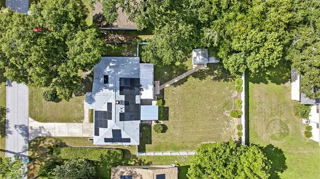 an aerial view of a house with a yard