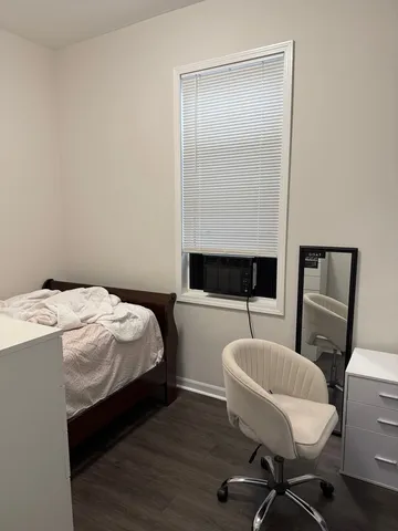 a bedroom with a bed and a chair