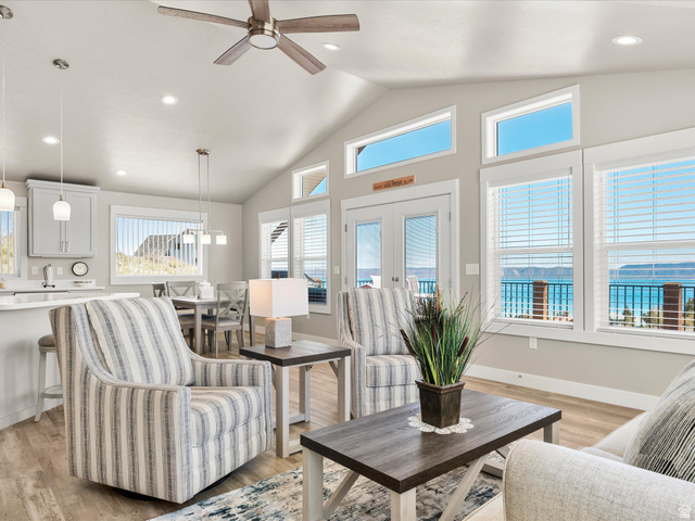 608 Fremont Road Fish Haven, ID 83287 - Photo 10 of 35 Open-concept living space featuring vaulted ceilings, wood-finish flooring, recessed lighting, and expansive windows