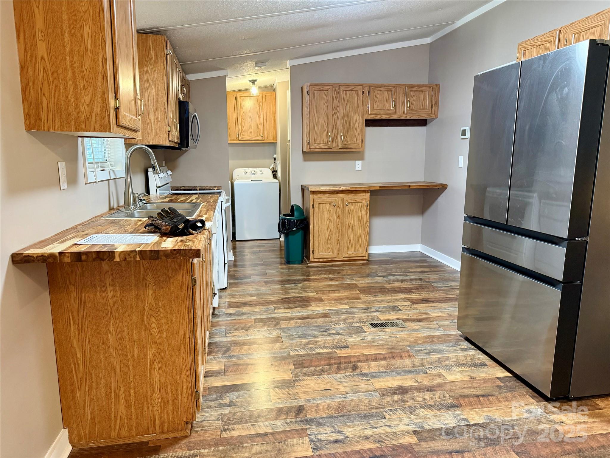 209 Romans Road China Grove, NC 28023 - Photo 8 of 25 a kitchen with stainless steel appliances granite countertop a refrigerator a stove and a sink