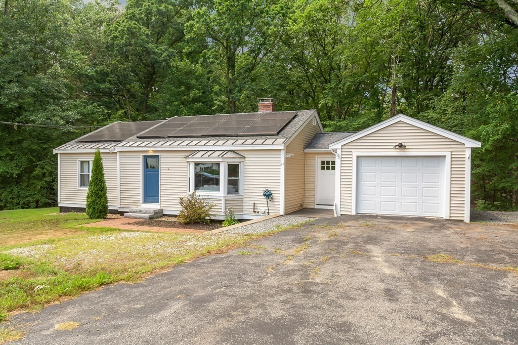 47 Whalom Road Lunenburg, MA 01462 - Photo 1 of 1 a front view of a house with a yard and garage