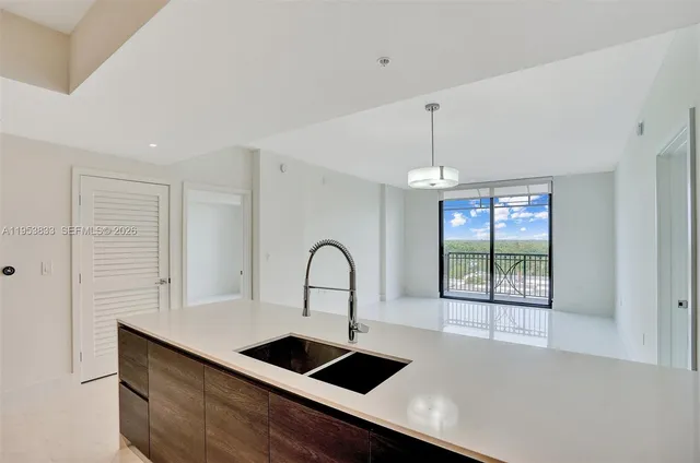 a view of a kitchen center island and stainless steel appliances