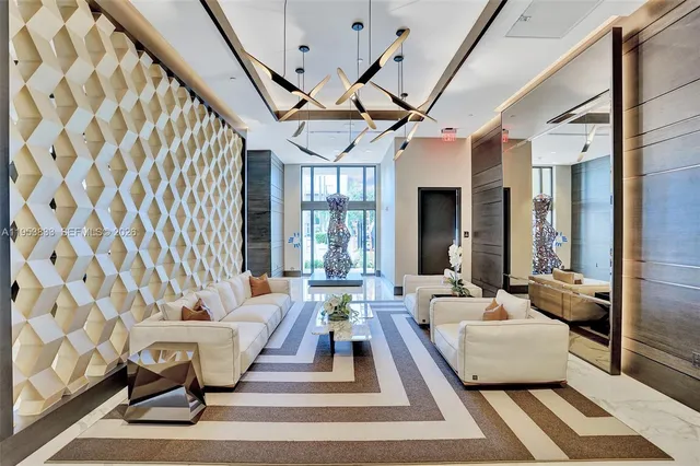a living room with furniture and a chandelier