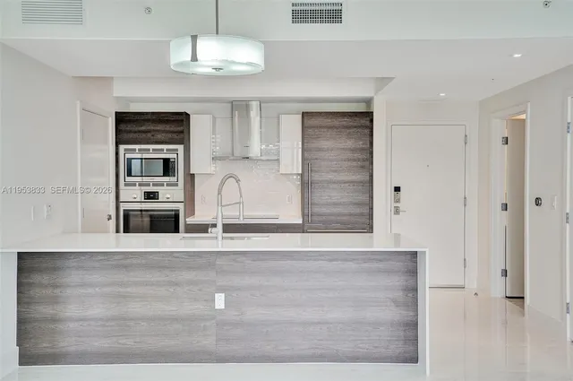 a kitchen with stainless steel appliances granite countertop a sink and a granite counter top