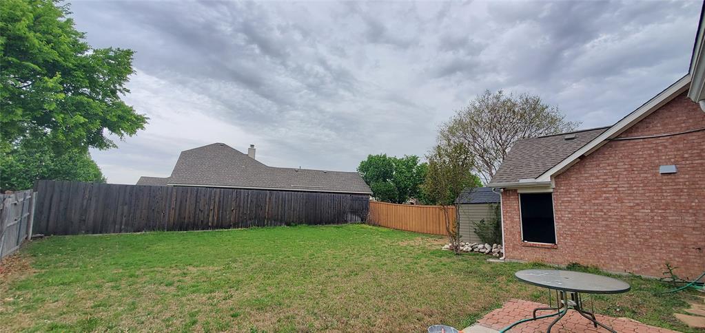 1003 Spring Tide Drive Wylie, TX 75098 - Photo 23 of 24 a backyard of a house with table and chairs