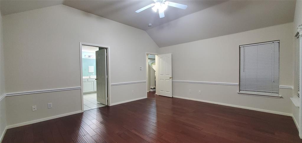 1003 Spring Tide Drive Wylie, TX 75098 - Photo 7 of 24 an empty room with wooden floor chandelier and windows