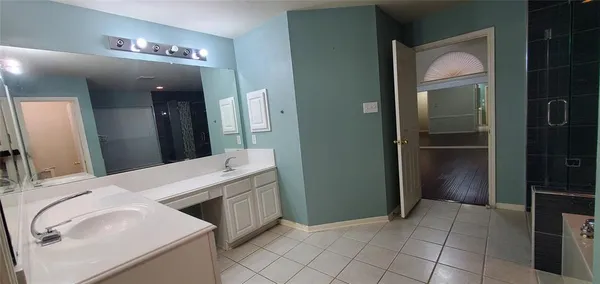 a bathroom with a shower and a sink