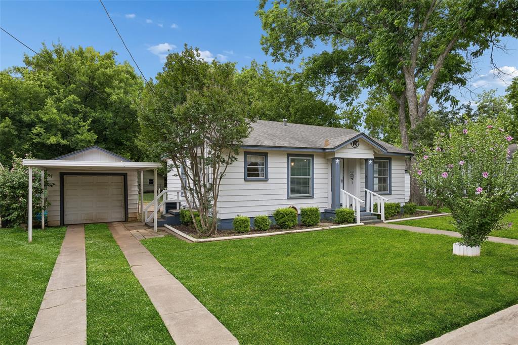 117 Moon Street Cleburne, TX 76033 - Photo 2 of 28 a front view of a house with a yard and garage