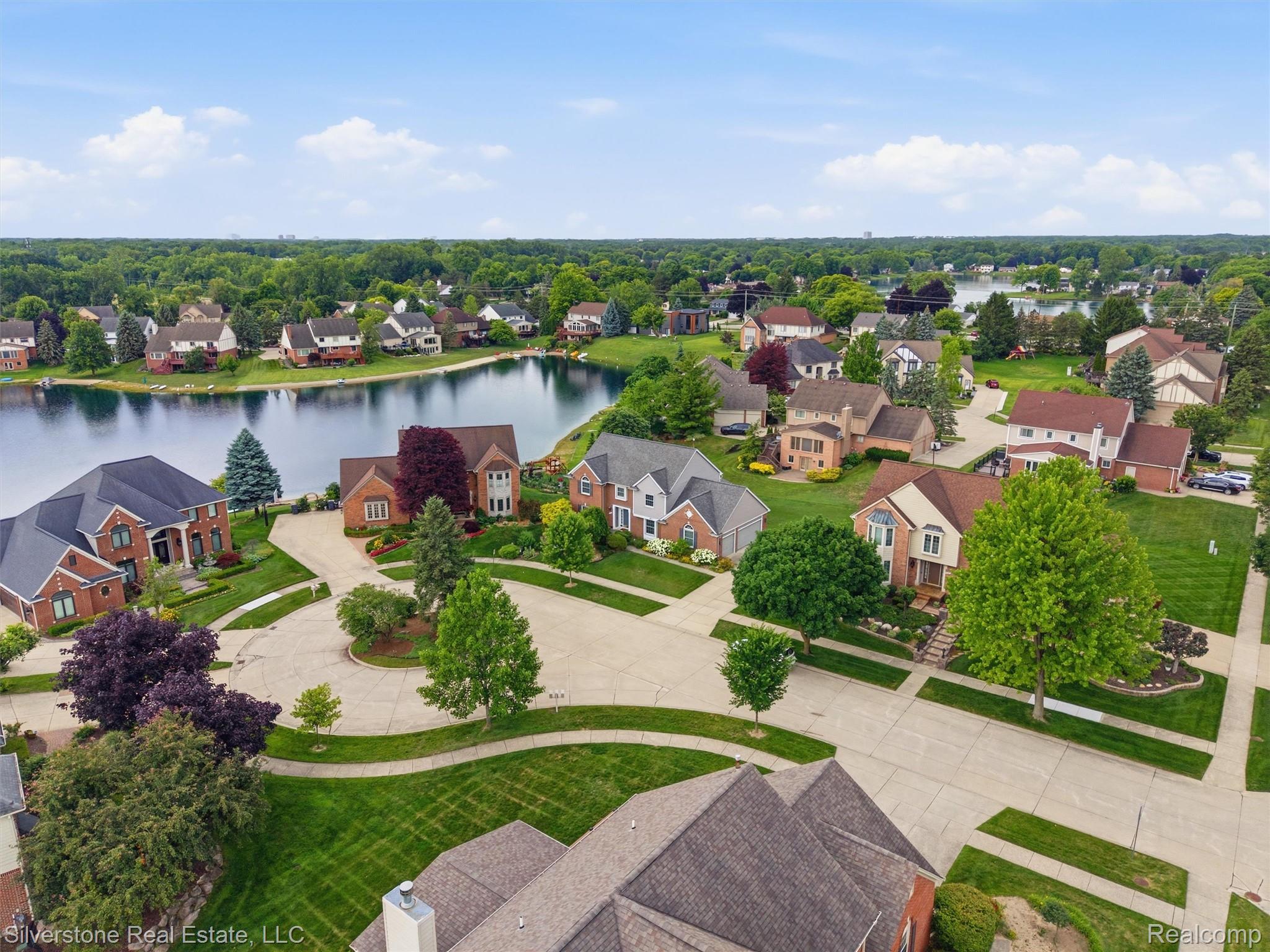 6577 Edith Court Troy, MI 48085 - Photo 60 of 61 Aerial landscape showcasing a residential community with waterfront properties, mature trees, and paved streets