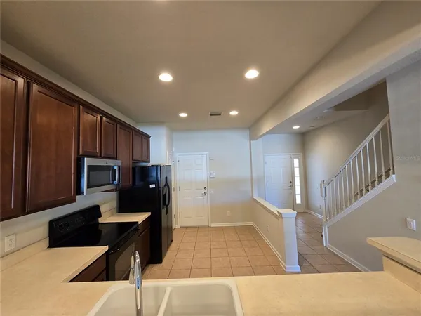 a kitchen with a refrigerator stove and cabinets