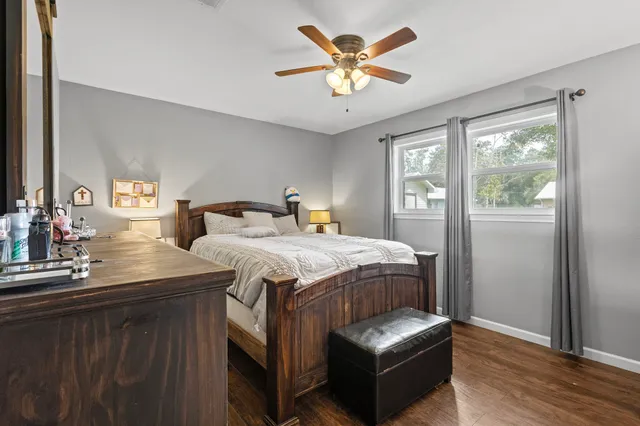 a bedroom with a bed and a chandelier
