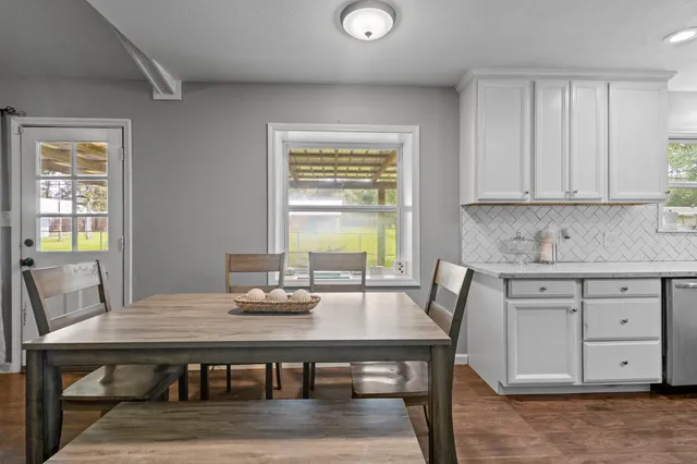a view of a dining room with furniture and wooden floor