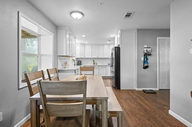 a view of a dining room with furniture and wooden floor