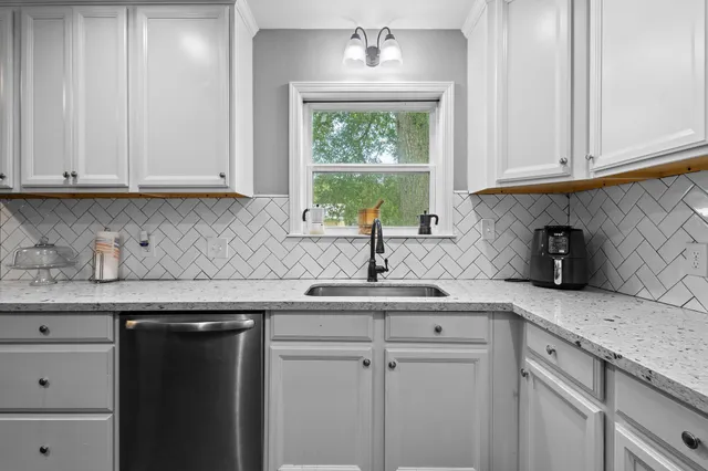 a kitchen with stainless steel appliances granite countertop a sink a cabinets and a counter space