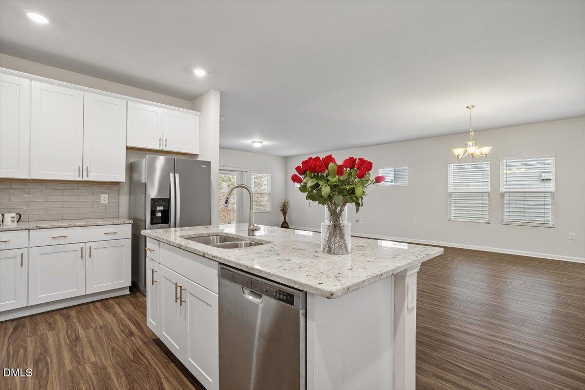 46 Coffee Tree Circle Clayton, NC 27527 - Photo 12 of 36 a kitchen with stainless steel appliances granite countertop a sink dishwasher and a refrigerator