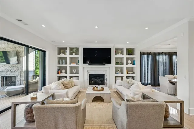 a living room with furniture a fireplace and a flat screen tv