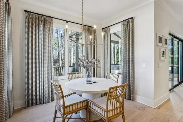 a view of a dining room with furniture window and wooden floor
