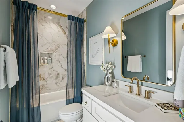 a bathroom with a sink vanity mirror and shower