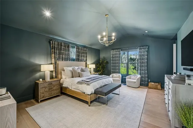 a spacious bedroom with a bed and large windows