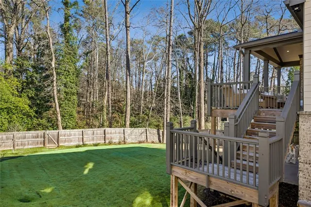 a view of yard with green space and deck