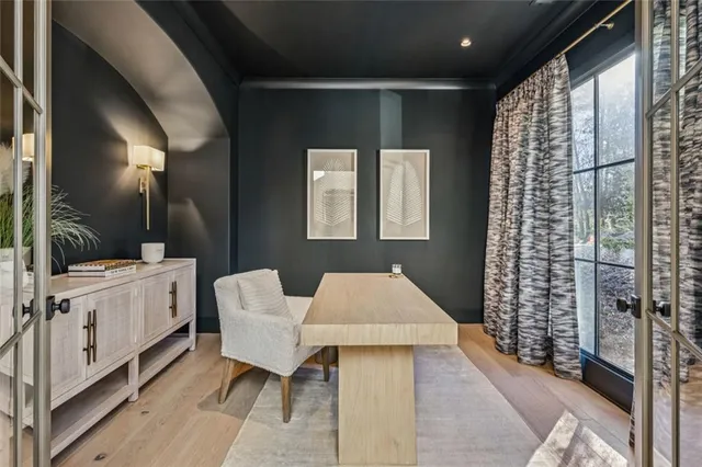 a very nice looking room with a large window and furniture