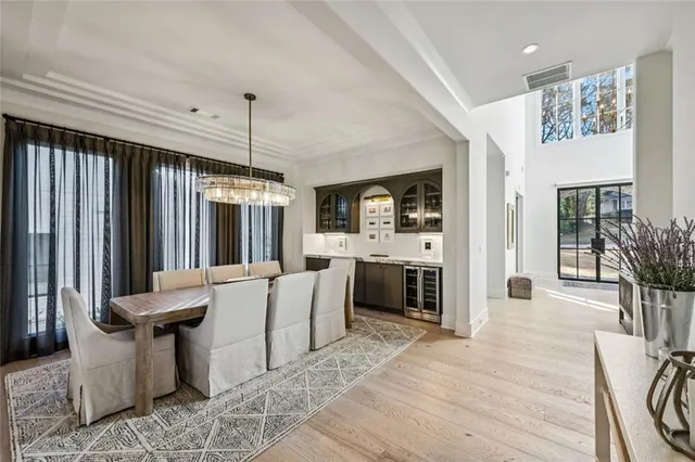 a living room with furniture a fireplace and a chandelier