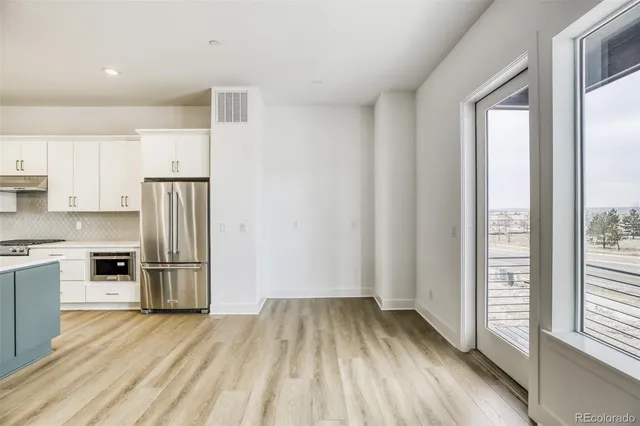 a view of kitchen and wooden floor