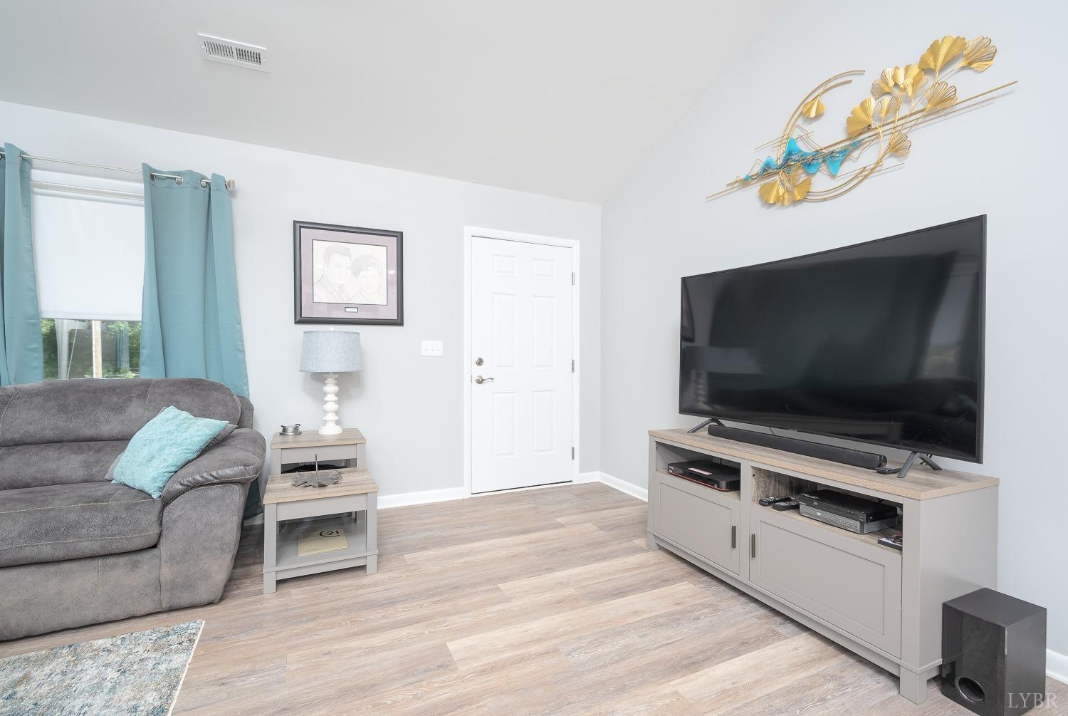 905 Gap Bridge Road Moneta, VA 24121 - Photo 11 of 48 a living room with furniture and a flat screen tv